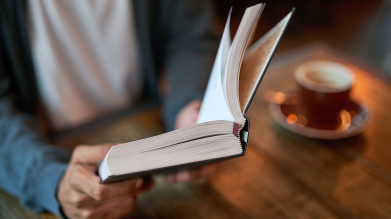 A person reading at a cafe