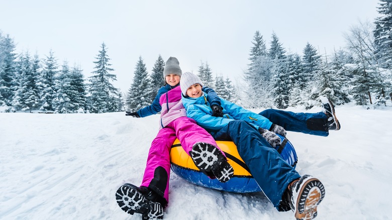 Kids having fun snow tubing