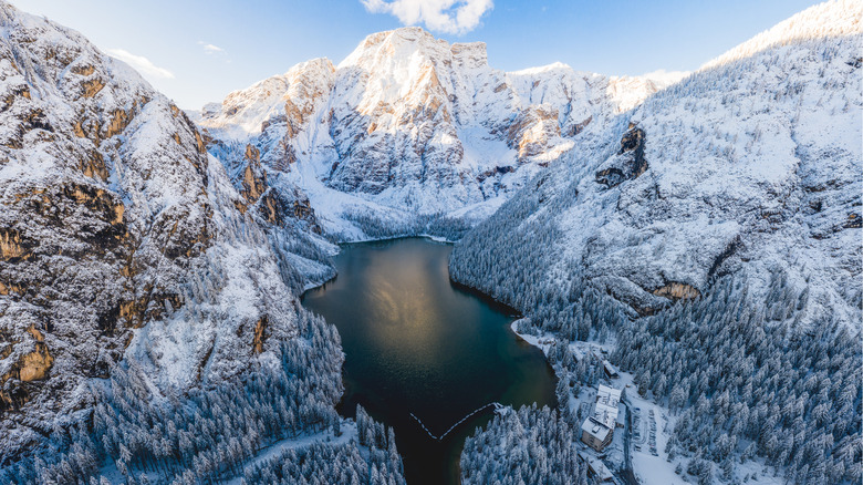 Lake surrounded by snow-covered Dolomite mountains