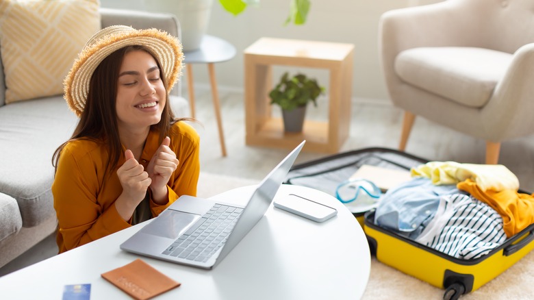 Woman happy about booking a vacation online