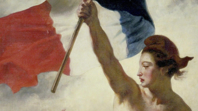 The face of Lady Liberty in the "Liberty Leading the People" painting, carrying a French flag