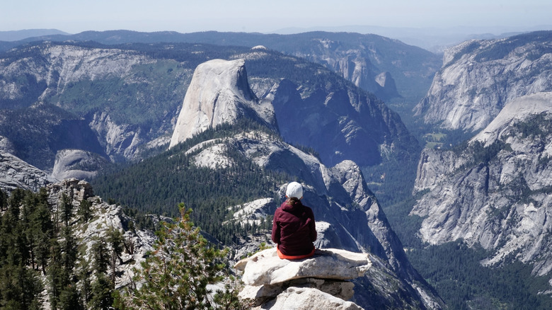 Hiker on the summit of Cloud's Rest overlooking Half Dome