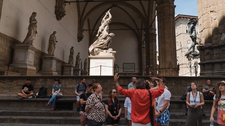 Tourists listening to a tour guide 