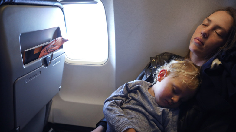 Family sleeping on window seat