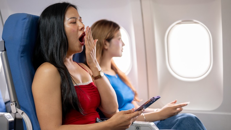 Woman yawning on flight