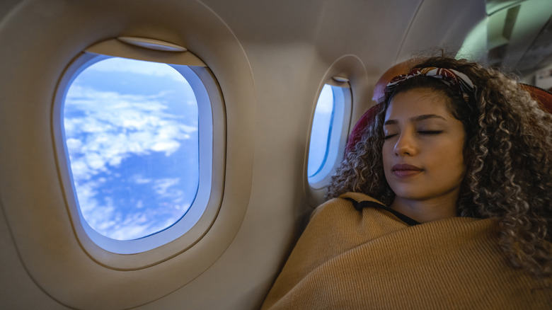 Woman sleeping on flight