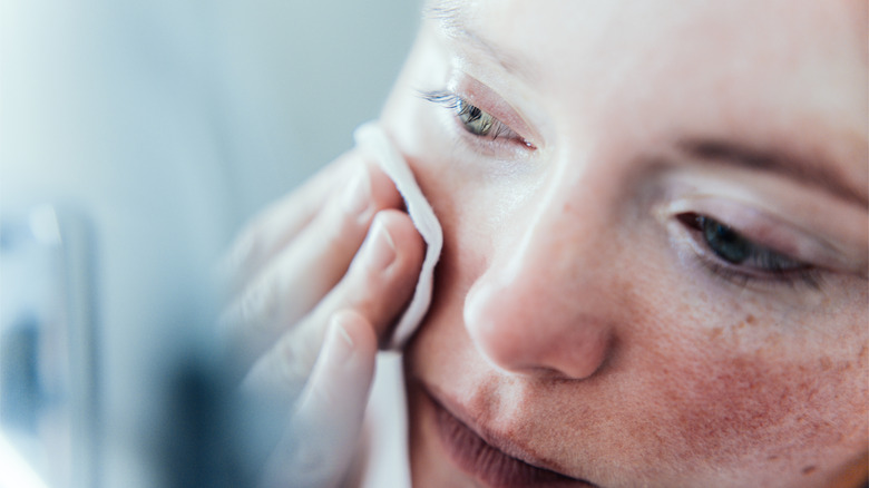 Woman taking off makeup