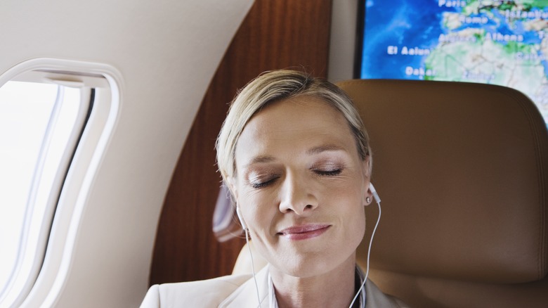 Woman relaxing on plane