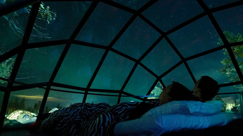 Watching northern lights from a glass igloo