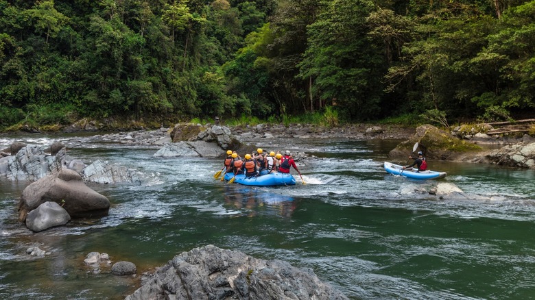 Participants navigating the river on a white-water raft in Costa Rica