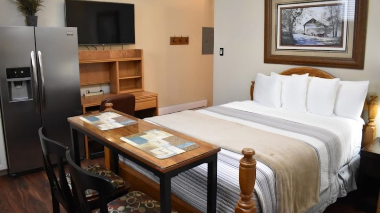 Bedding and a refrigerator at the Silver Horseshoe Inn in St. Anthony