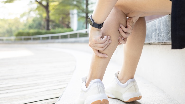 Person stretching cramped leg