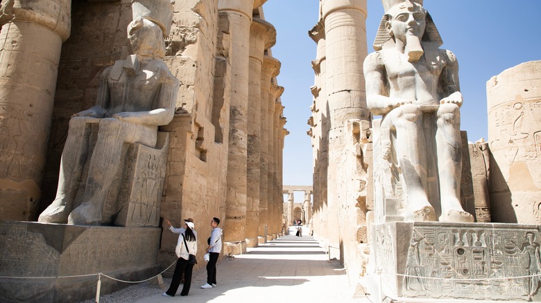 People exploring an ancient site in Luxor, Egypt