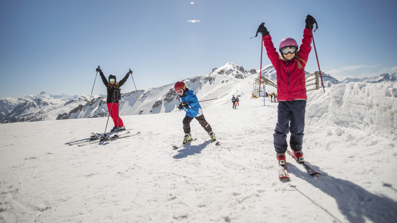 Three children skiing on a slope