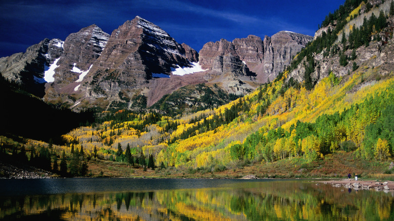 mountains and yellow trees surrounding a lake