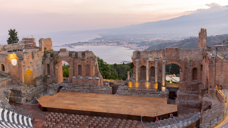 Ancient Greek-Roman theater in Taormina with the coastline backdrop