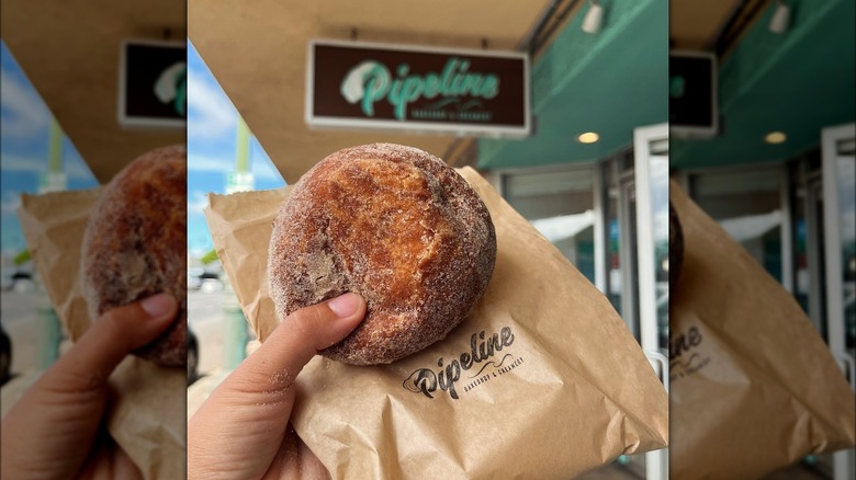 Person holding a malasada