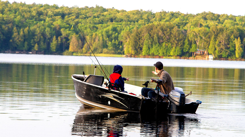 Man and boy fishing on a lake in a boat