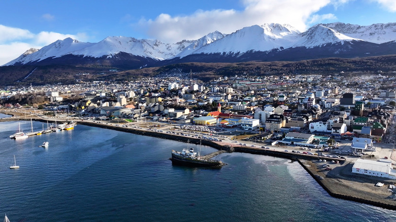 Aerial view of Ushuaia with snowy mountains behind it