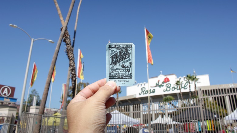 Hand holding an admission ticket to the flea market