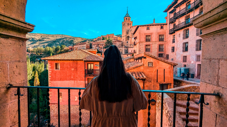 Woman overlooking Albarracín from a balcony