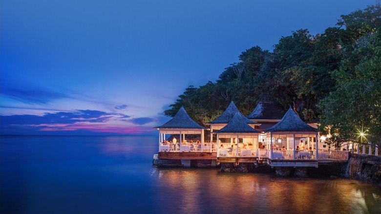 Night view of Bayside, the over-water Asian fusion restaurant at Couples Tower Isle