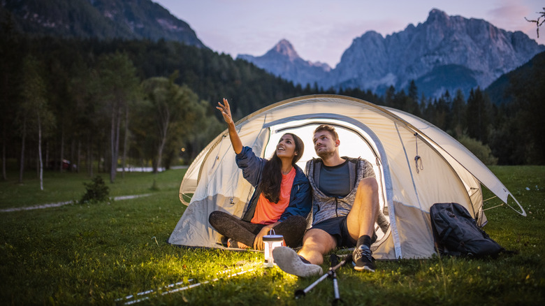 Couple camping near mountains