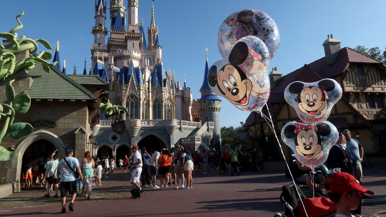 Mickey Mouse balloons floating near Cinderella's Castle in Disneyworld, Florida.