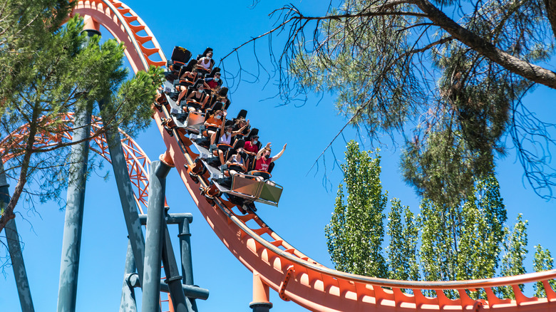 Visitors at Madrid Amusement Park riding a roller coaster.