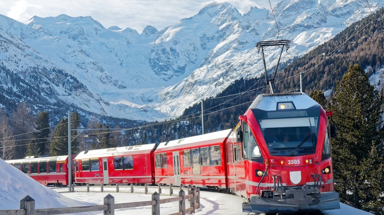 A train cutting through the snowy Swiss Alps