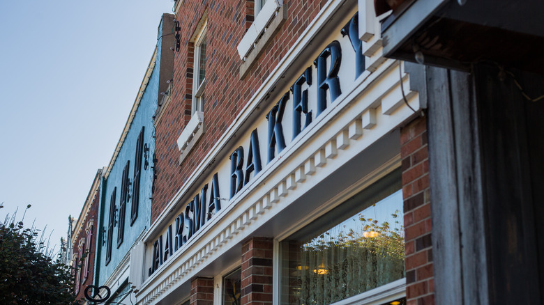 The outside of Jaarsma Bakery, which has a blue and white sign and brick front, in Pella, Iowa