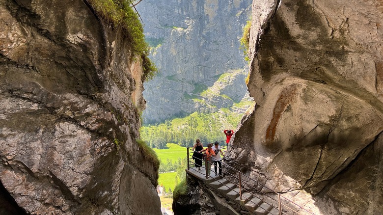 People walking on a platform at Trümmelbach Falls in Switzerland