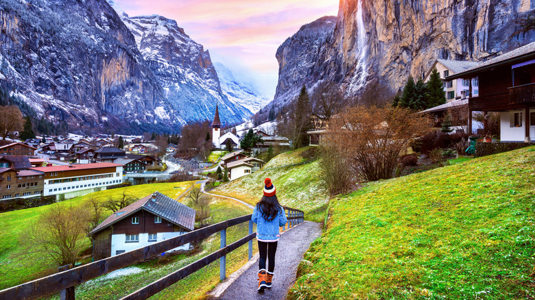 A woman walking through a village in Switzerland.