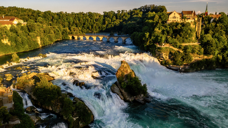 The Rhine Falls against a blue sky in Switzerland.