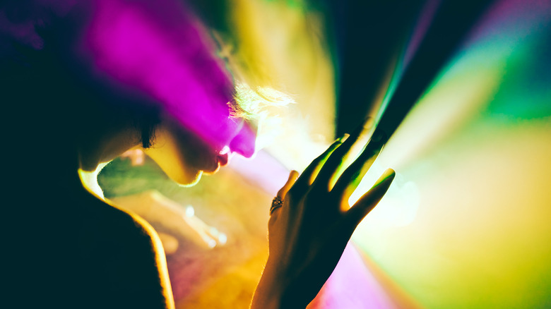 Woman immersed in colorful lights