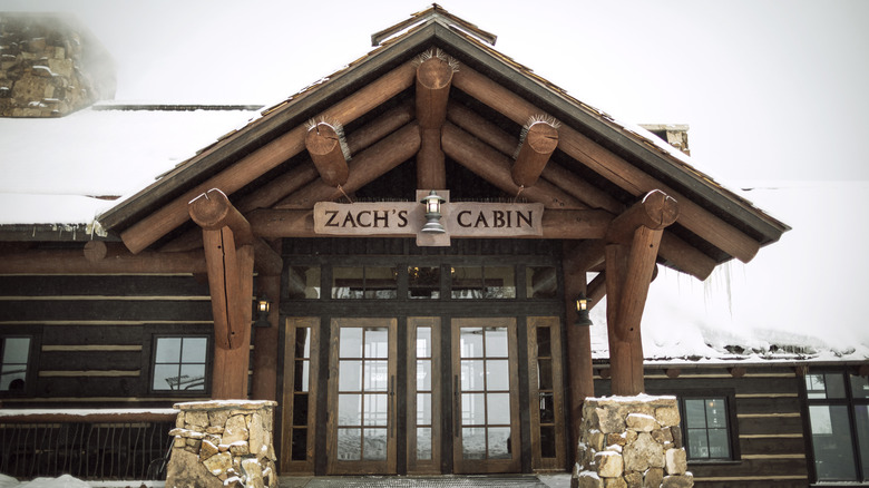 Exterior view of the front entrance to Zach's Cabin in the snow