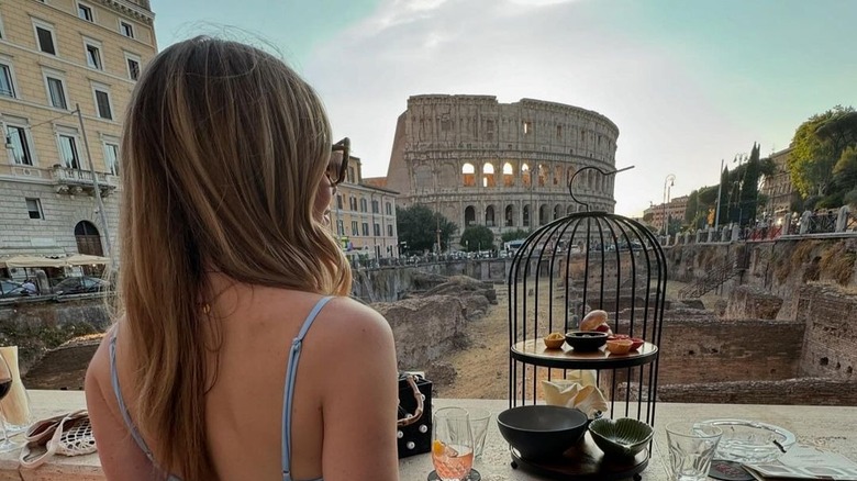 A woman looking out from The Court courtyard bar at the Colosseum in Rome