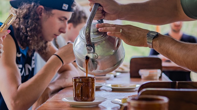 North Fields guide pouring coffee at the tasting table