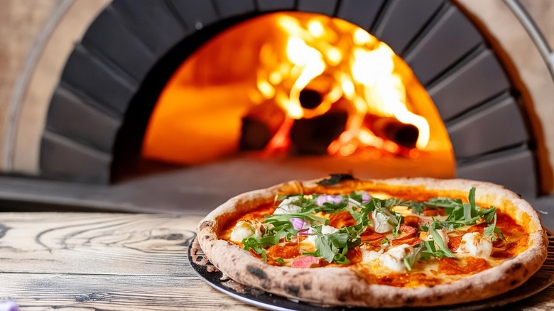 Pizza near firewood oven