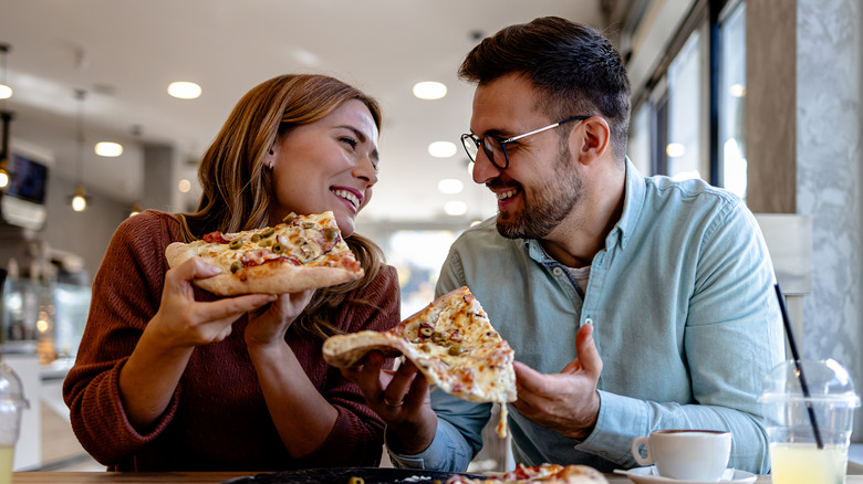 Couple eating pizza together