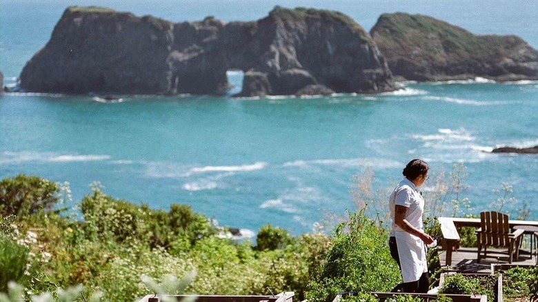 chef walks along coastline