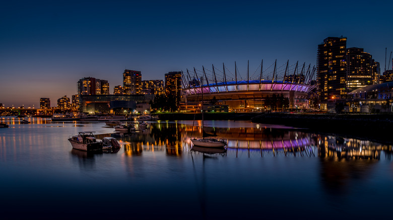 View of BC Place Stadium and boats in the harbor in Vancouver at sunset