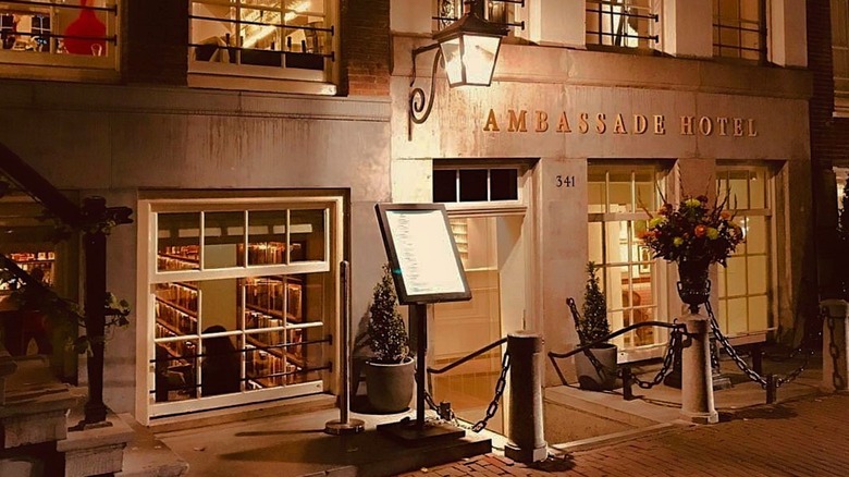 The entry to the Ambassade Hotel at night.