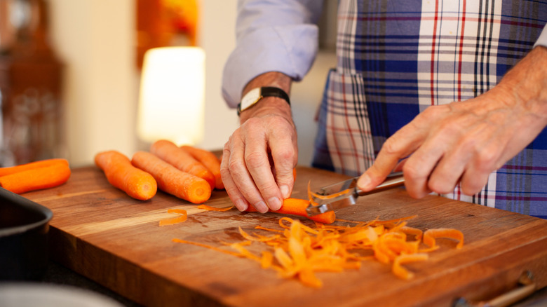 Man peeling carrots