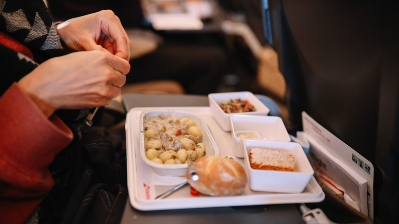 Woman eating in-flight meal