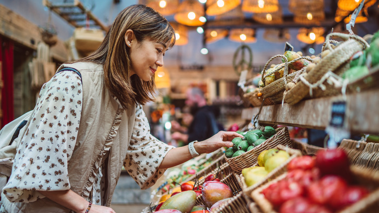 Woman selecting produce from basket