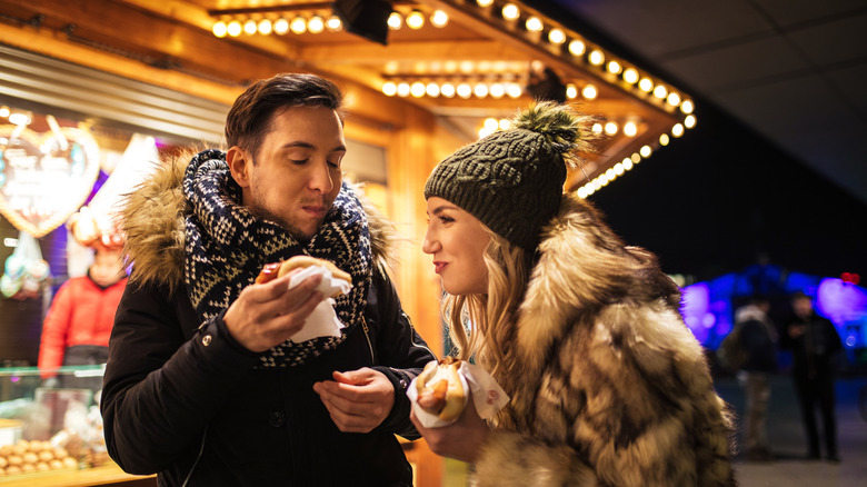 Couple enjoying Christmas market food