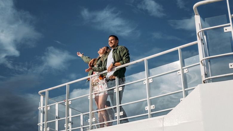 Couple enjoying the sunshine on a cruise ship