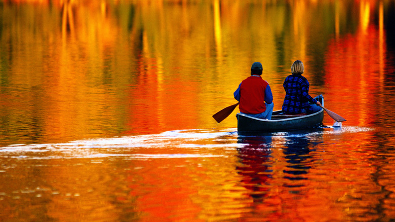 Couple canoeing in the fall