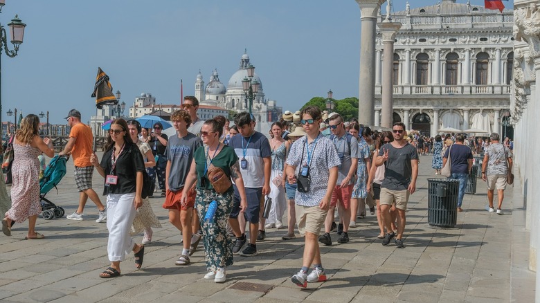 Tourist group walking in Venice square